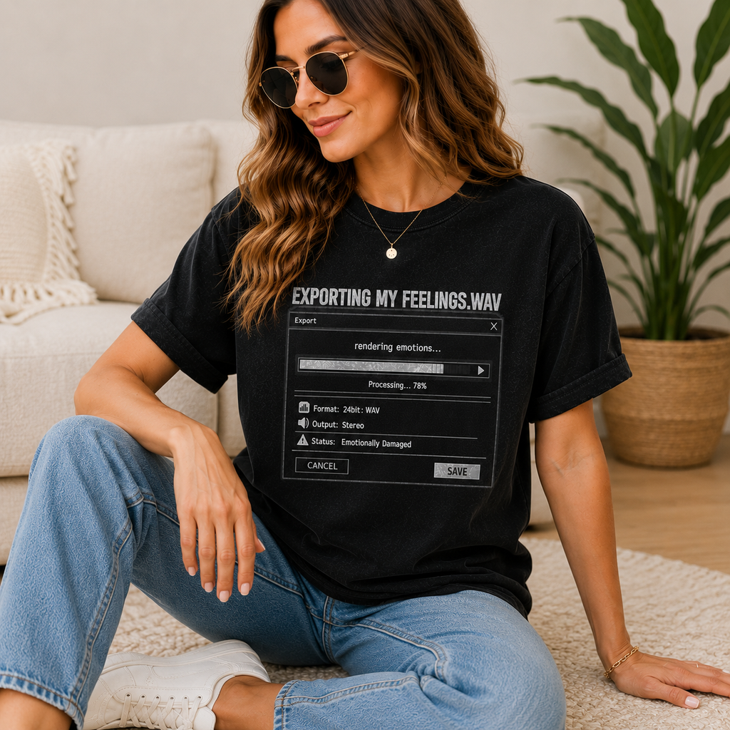 A woman wearing a black graphic t-shirt with a computer export error message design, paired with blue jeans and sunglasses, sitting in a cozy living room setting.