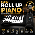 A portable roll-up piano shown on a dark stage-like background with promotional text and feature icons. The product consists of a black and white flexible keyboard body with an attached black control panel.