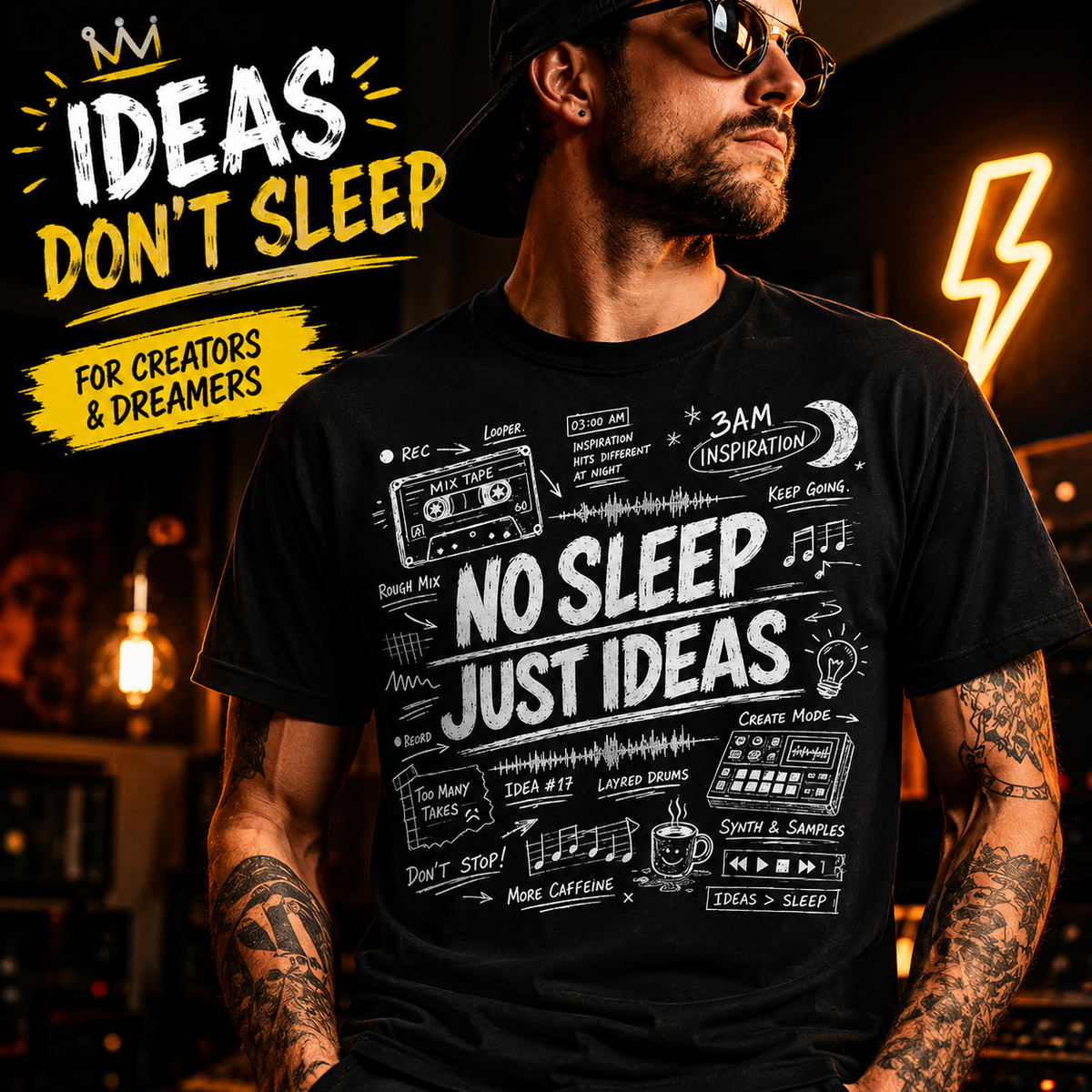 A man wearing a black graphic t-shirt with white hand-drawn notes and the text 'NO SLEEP JUST IDEAS'. The background is a dark, warm-toned studio with neon lights, and a yellow graphic overlay in the top left reads 'IDEAS DON'T SLEEP FOR CREATORS & DREAMERS'.